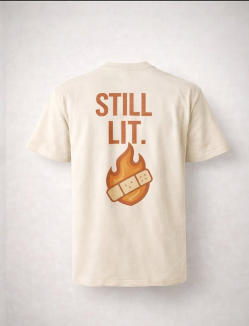 STILL HEALING. STILL LIT.™ T-SHIRT